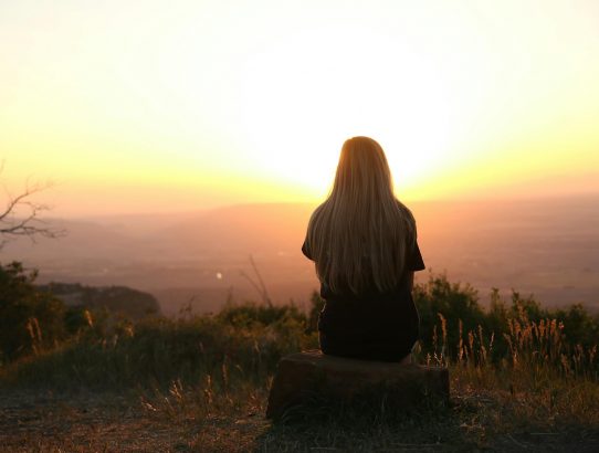 woman looking at sunset